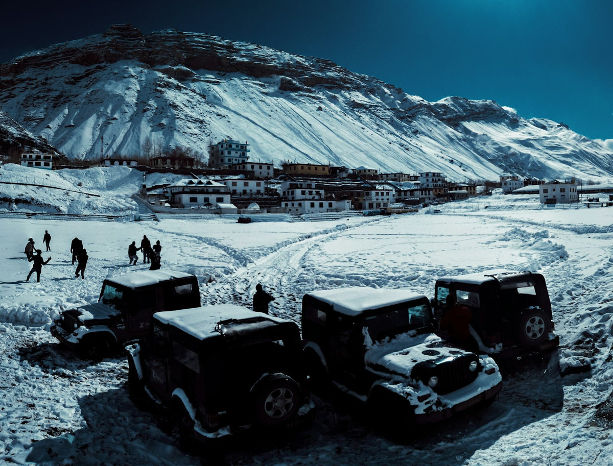 black and gray tractor on snow covered ground during daytime