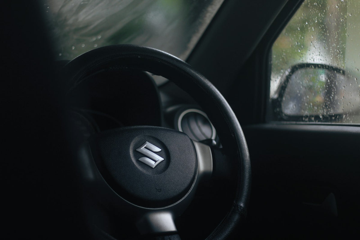 a steering wheel of a car in the rain