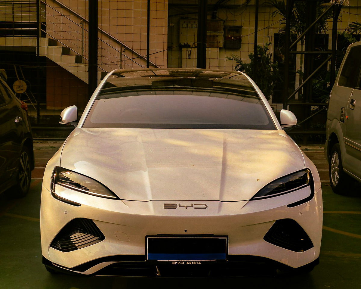 A white sports car parked in a parking lot