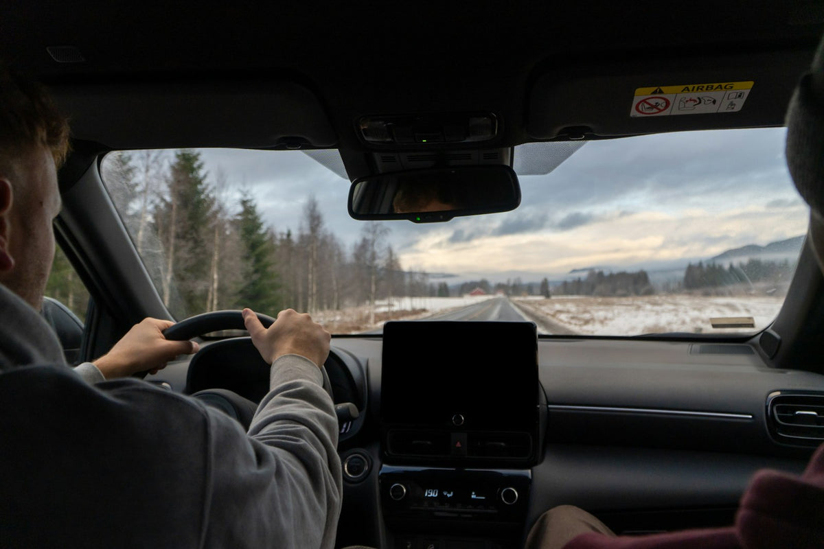 A man driving a car on a snowy road